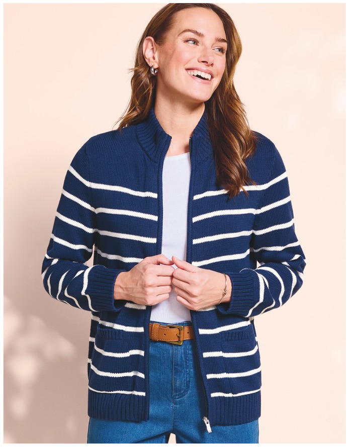 woman looking to the side wearing a navy and white stripe cardigan with white tee underneath